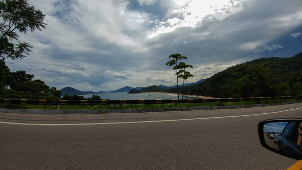 Car on the road, traveling BR 101 in Ubatuba Sao Paulo dirigir stock pictures, royalty-free photos & images