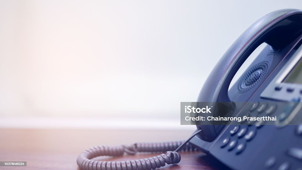 close up soft focus on telephone devices at office desk for customer service support concept Telephone Stock Photo