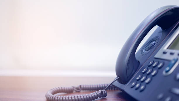 close up soft focus on telephone devices at office desk for customer service support concept close up soft focus on telephone devices at office desk for customer service support concept landline phone stock pictures, royalty-free photos & images