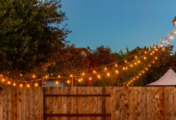 Backyard party lights lights hanging from the house for a party garden parties stock pictures, royalty-free photos & images