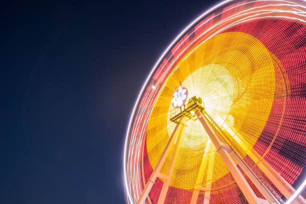 istock Ferris long exposure and night illumination attraction 1037926294