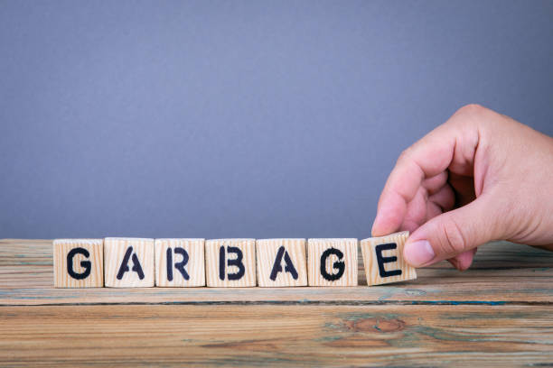 istock garbage. Wooden letters on the office desk 1037965802
