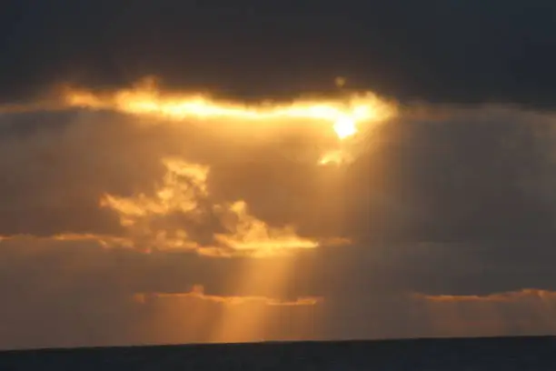 Sunrise in the sea of northeastern Brazil with rays of sunshine highlighted