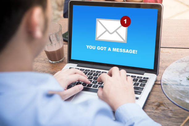 istock Man working on laptop and got a message from someone at outdoor cafe 1037977620