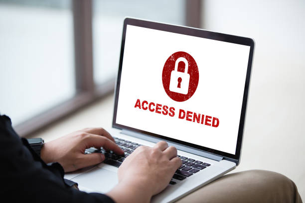 istock Protection security system concept. Man working on laptop with access denied text on screen. 1037977702