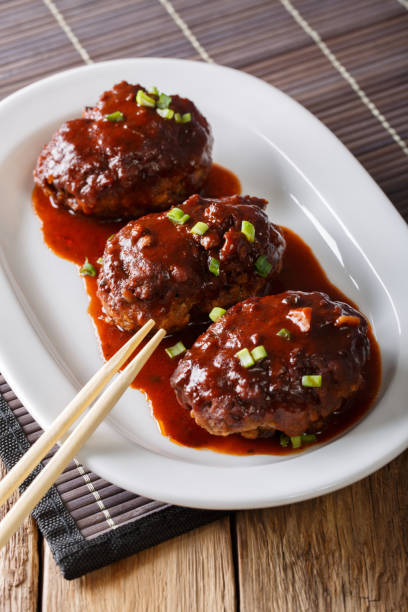 istock Japanese food: hambagu steak with gravy close-up on a plate. vertical 1037983758