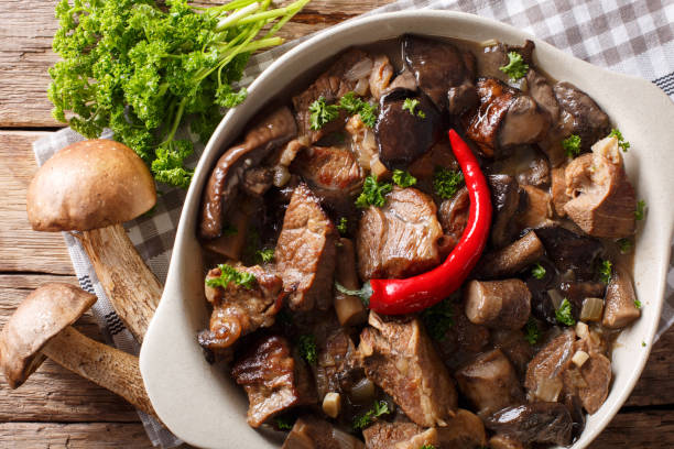istock Stew beef with wild forest mushrooms and chili close-up. Horizontal top view 1037984058