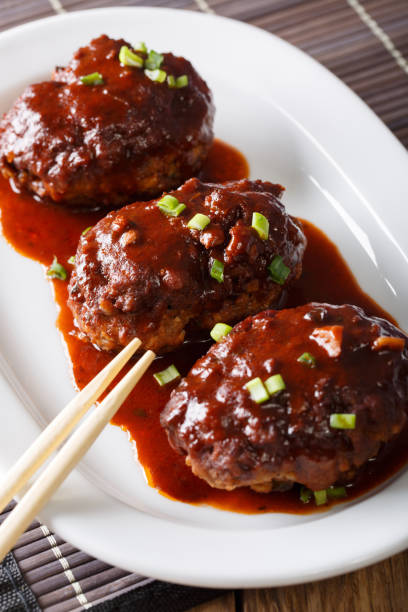 istock Japanese hambagu chopped steak with a gravy close-up. vertical 1037984450