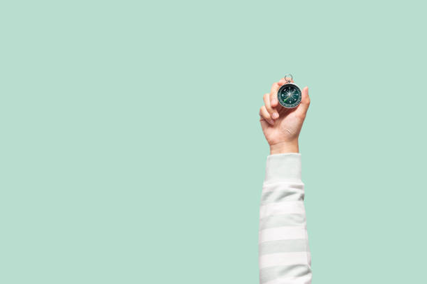 Woman holding compass in one hand
