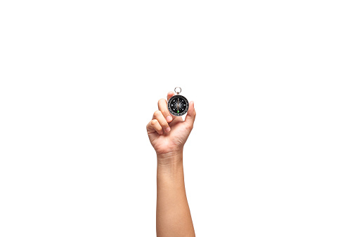 Hand holding compass in one hand  on white background, searching direction with compass.