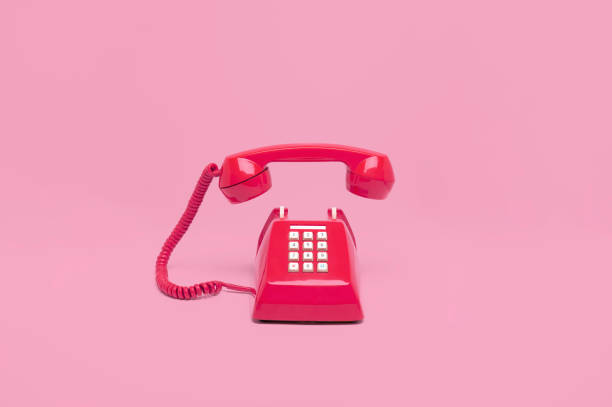 istock Retro pink telephone on pink background 1037984700
