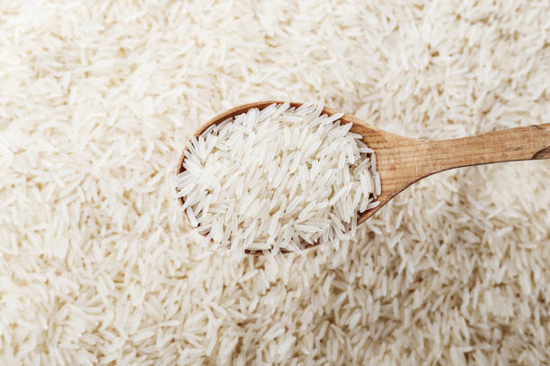 istock Rice and wooden spoon. 1037987190