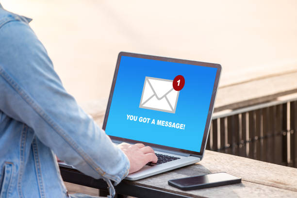 istock Man working on laptop and got a message from someone at outdoor cafe 1037987500