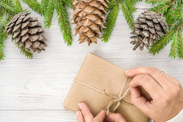 istock New Year's background. Christmas composition. Hands are preparing a New Year's gift 1037988126