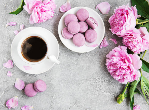 istock Pink peony with coffee and macarons 1037988418