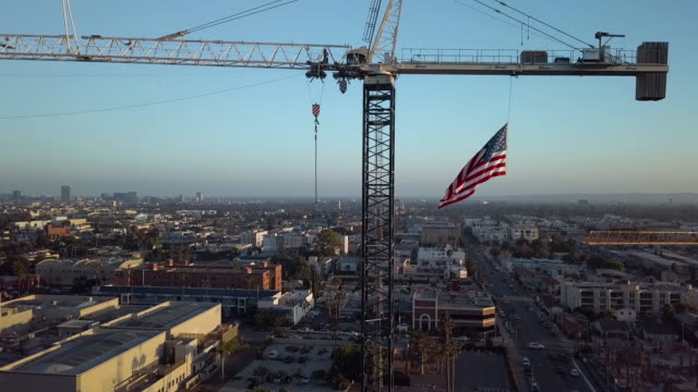 Construction Crane with American Flag- Aerial Drone Shot