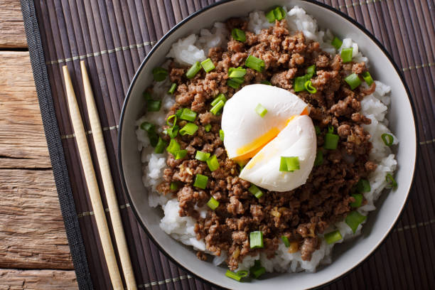 istock Beef Soboro with egg poached, rice and green onion close-up. Horizontal top view 1037999894