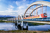 Suburb passenger train drive through the viaduct towards the Tatra Mountains
