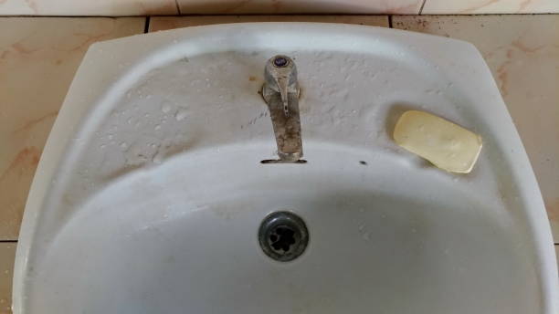 istock Old faucet, wash basin with soaps. 1038007530