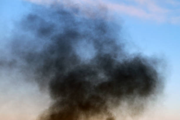istock dark smoke pillar against day sky background. 1038017840