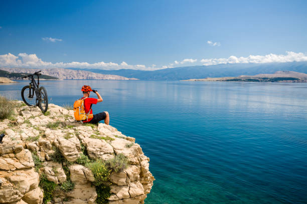 istock Mountain biker looking at view and riding on bike 1038030282