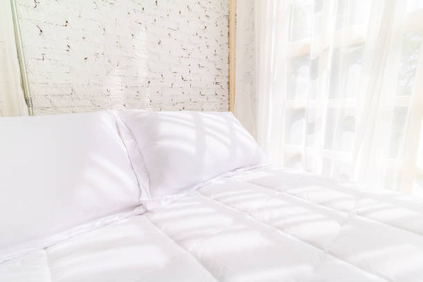 istock Bed in the morning with natural light from the window. Bedding room background. 1038039224