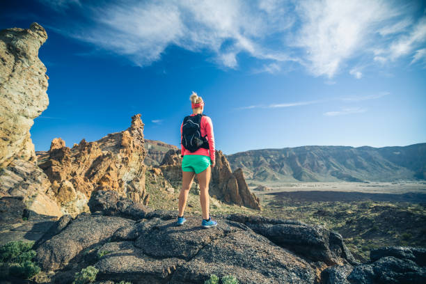 istock Woman hiker reached mountain top, backpacker adventure 1038044672