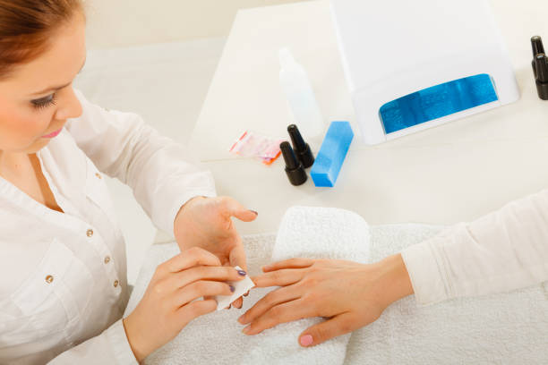 istock Woman making manicure using nail polish remover 1038045048