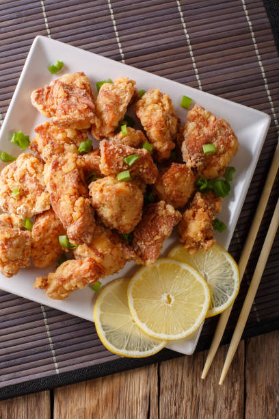 istock karaage -  Japanese style fried chicken closeup. Vertical top view 1038056604
