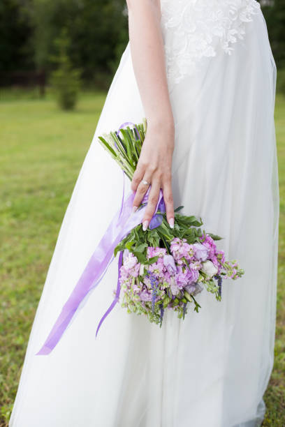 istock Bride holds a wedding bouquet, wedding dress, wedding details 1038071240
