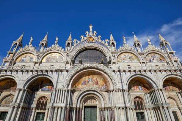istock Saint Mark low angle view basilica facade in Venice, blue sky in Italy 1038071820
