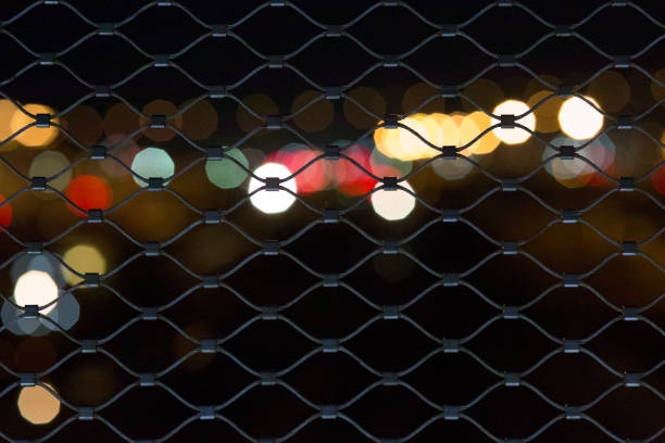 istock Out of focus light through fence 1038096450