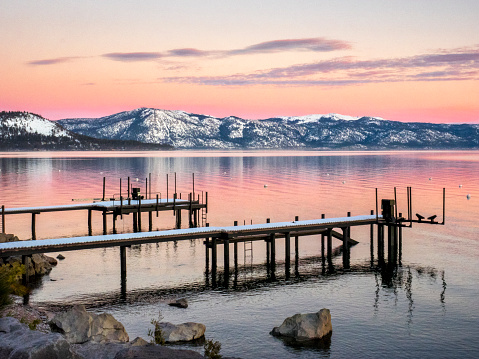 Dock with lake, mountains, and sunset in the background