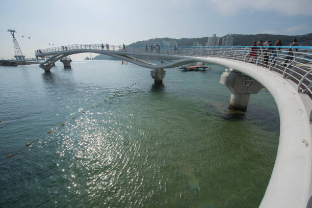 November 10, 2017, South Korea: People are seen walking on Busan's Songdo Skywalk, the longest skywalk on the water in South Korea. Visitors can see the ocean under their feet through floors made of tempered glass.