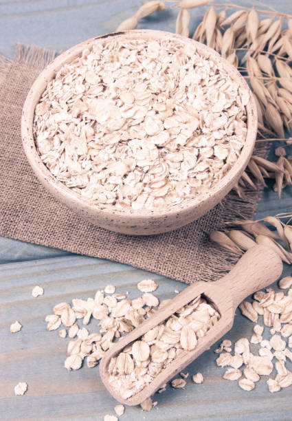 istock Oat flakes in a bowl on the blue board. 1038108080