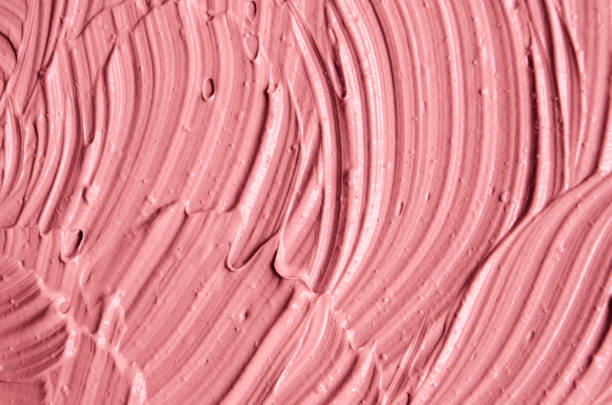 Pink cosmetic clay (facial mask, cream) texture close up, selective focus. Abstract background with brush strokes. Pink cosmetic clay (facial mask, cream) texture close up, selective focus. Abstract background with brush strokes. make up brush photos stock pictures, royalty-free photos & images