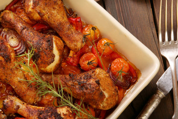 istock Roasted chicken legs on the ceramic bowl cooked with vegetables 1038126616