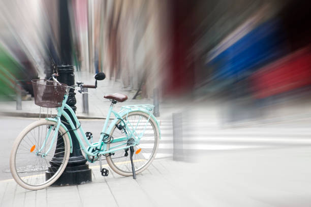 Bicycle on the sidewalk, city life, zebra crossing in the background. City street  perspective, periphery defocused, copy space on the right. Physical activity, environmental conservation, Gijon, Asturias, Spain.