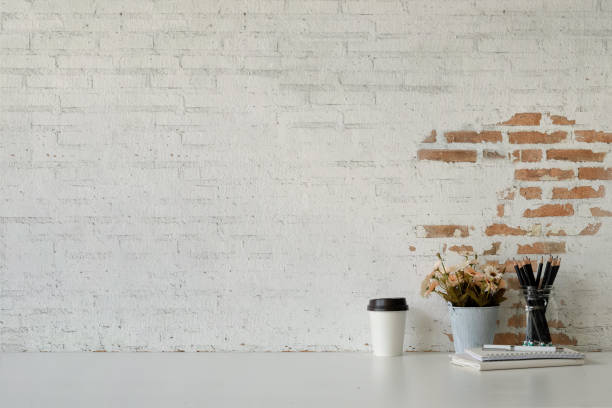 istock Workspace white desk paper coffee mug, flower, notebook and copy space. 1038132994