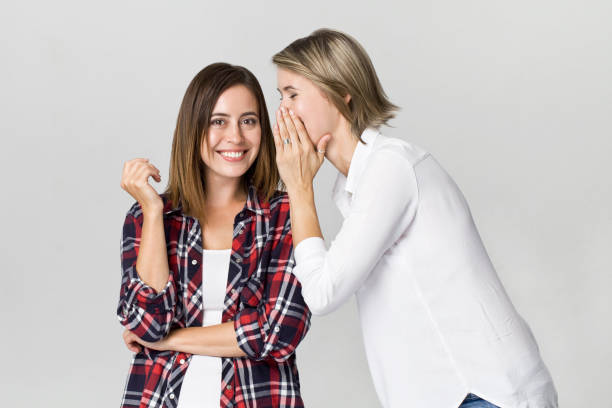 istock Joyfull young women whispering and gossiping 1038144834