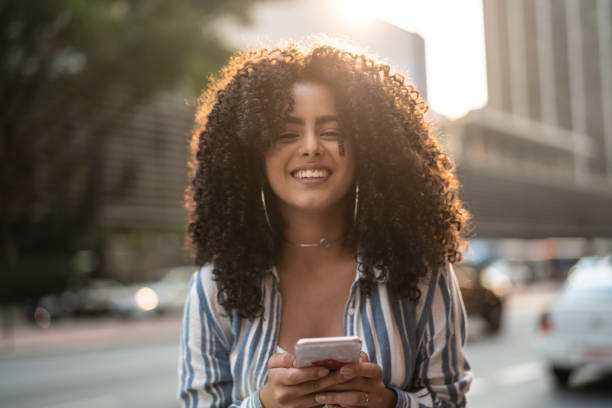 chica joven usando móviles al aire libre - central unit fotografías e imágenes de stock