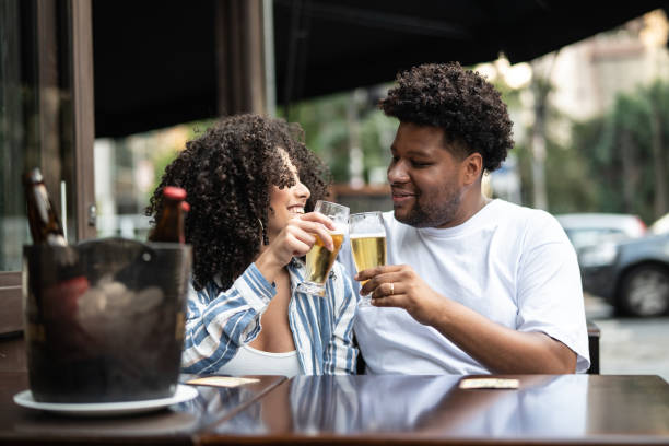 istock Happy young couple toasting with beer in a bar 1038145384