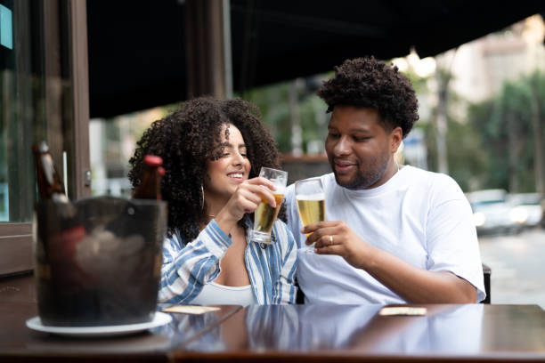 istock Happy young couple toasting with beer in a bar 1038145392