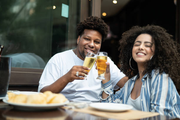 istock Happy young couple drinking beer in a bar - Portrait 1038145444