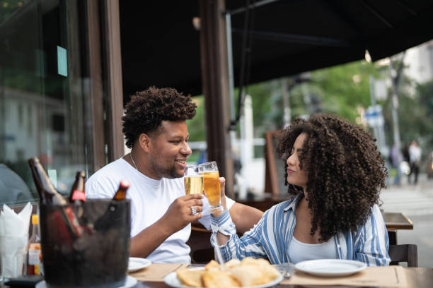 istock Happy young couple toasting with beer in a bar 1038145464