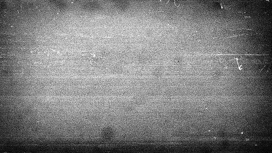 Noisy film frame with heavy scratches, dust and grain. Abstract old film background