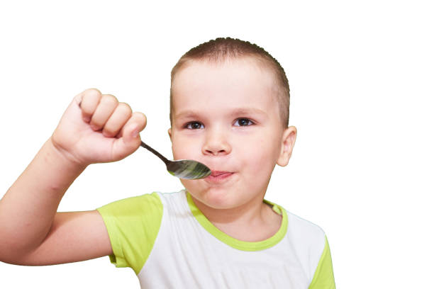 istock Little boy with spoon in hand. 1038152242