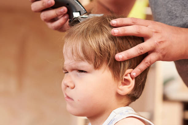 istock A man cuts machine child at home. 1038153944