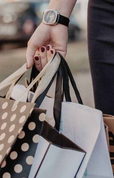 Woman hand holding a lot of purchases stock photo