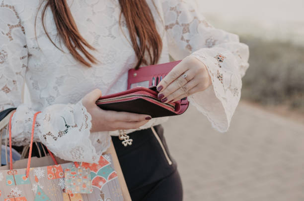 Girl holding a wallet after shopping stock photo